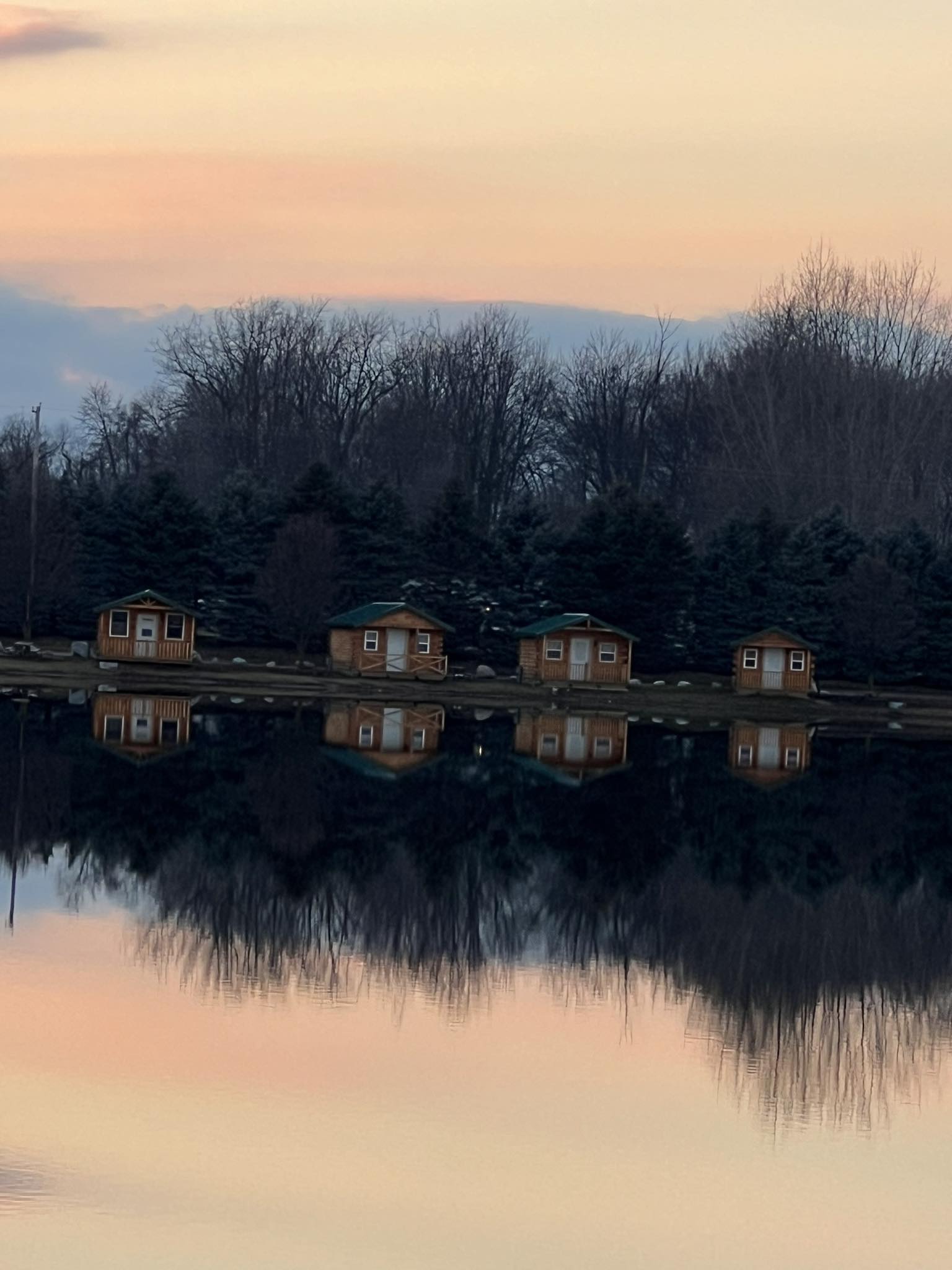 Cabins at sunset with lake reflection